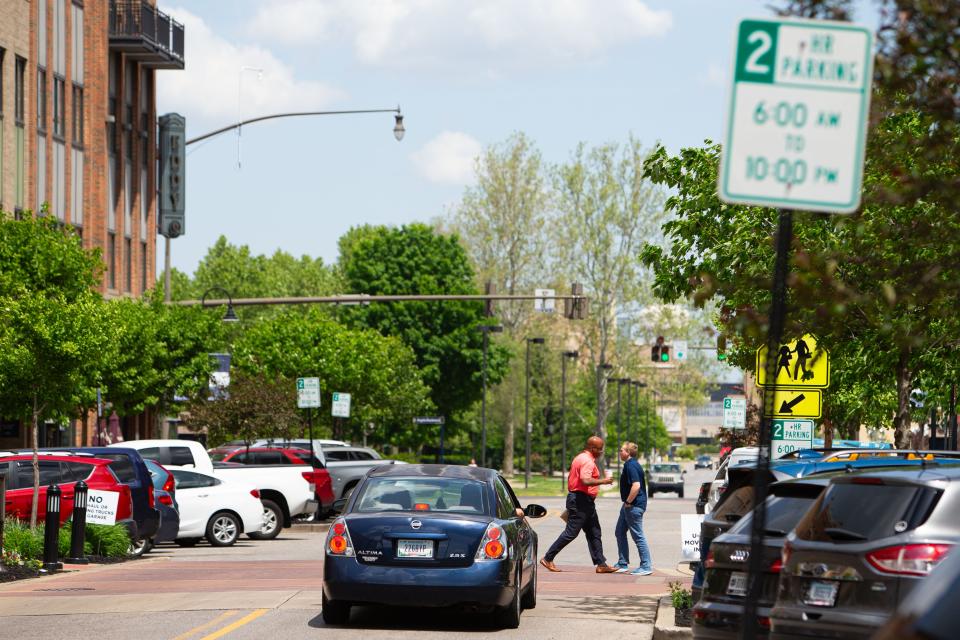 Pedestrians cross North Eddy Street as a car waits on Monday, May 13, 2024, in South Bend.