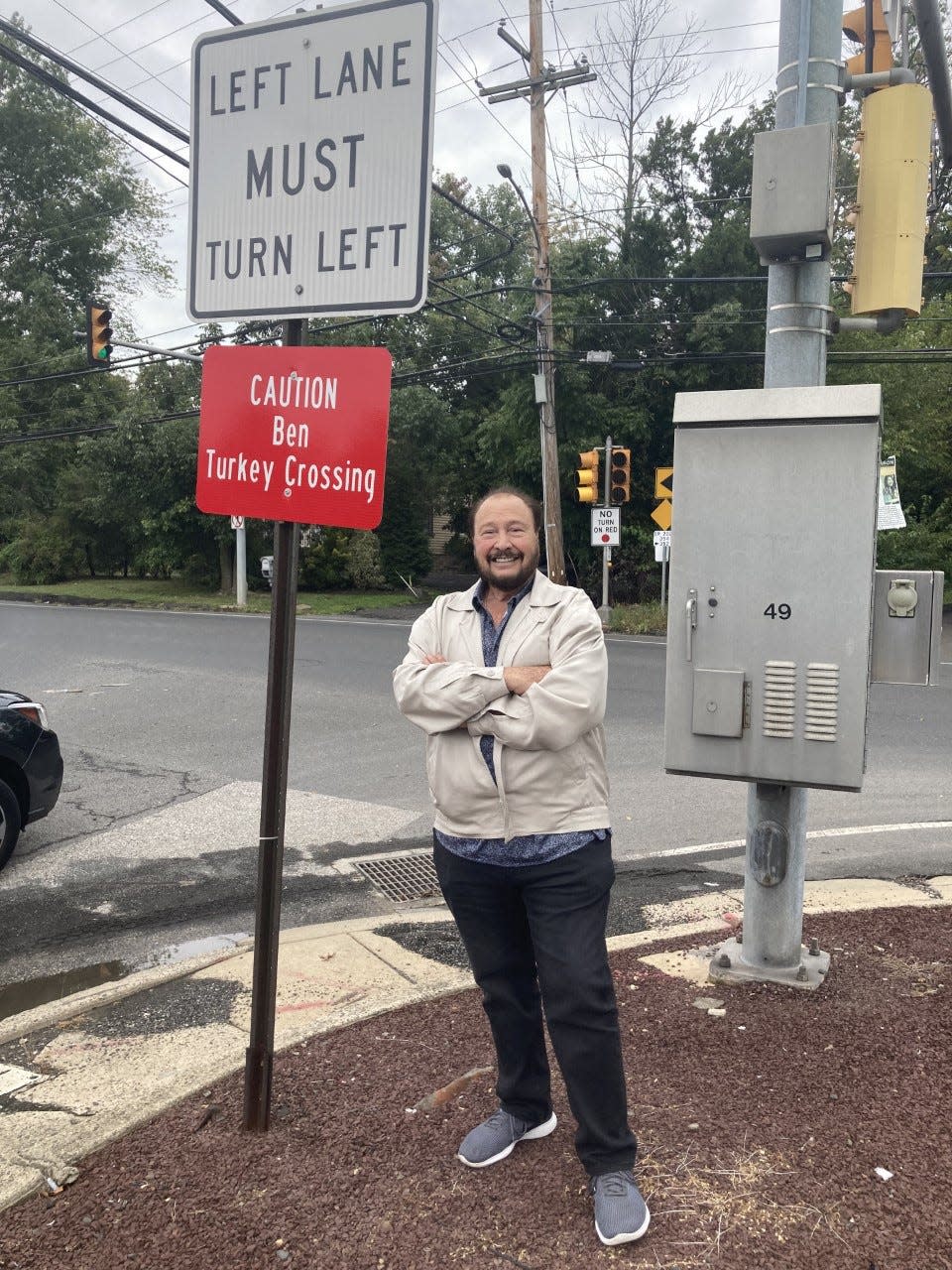 Bensalem Mayor Joseph DiGirolamo, in a Sept. 29, 2021 photo, poses at a sign the township posted at Bristol and Galloway roads to warn motorists about Ben the Turkey, who was frequently seen at the intersection.