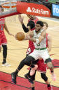 Boston Celtics' Jayson Tatum (0) drives for a reverse layup past Chicago Bulls' Lauri Markkanen during the first half of an NBA basketball game, Monday, Jan. 25, 2021, in Chicago. (AP Photo/Charles Rex Arbogast)