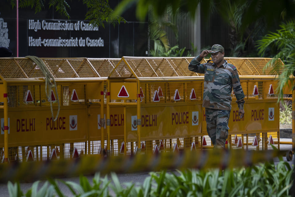 An Indian paramilitary soldier stands guard next to a police barricade outside the Canadian High Commission in New Delhi, India, Tuesday, Sept. 19, 2023. Tensions between India and Canada are high after Prime Minister Justin Trudeau's government expelled a top Indian diplomat and accused India of having links to the assassination in Canada of Sikh leader Hardeep Singh Nijjar, a strong supporter of an independent Sikh homeland. (AP Photo/Altaf Qadri)