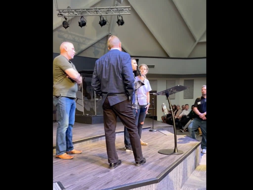 Rev John Lowe II is confronted by a congregant at the New Life Christian Church & World Outreach in Warsaw, Indiana on Sunday (Facebook/video screengrab)