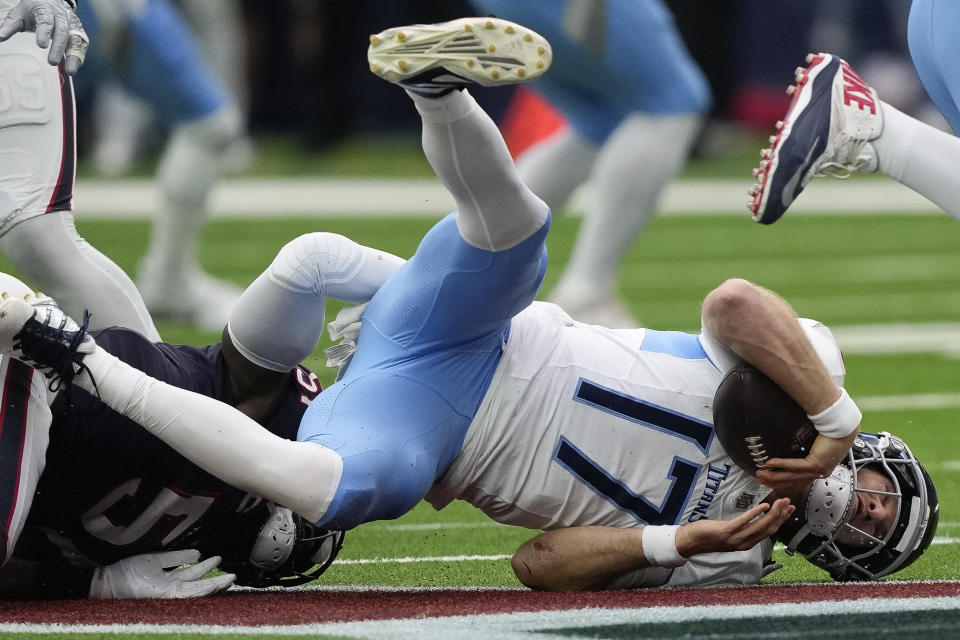 Tennessee Titans quarterback Ryan Tannehill (17) is sacked by Houston Texans defensive end Will Anderson Jr., left, during the first half of an NFL football game Sunday, Dec. 31, 2023, in Houston. (AP Photo/David J. Phillip)