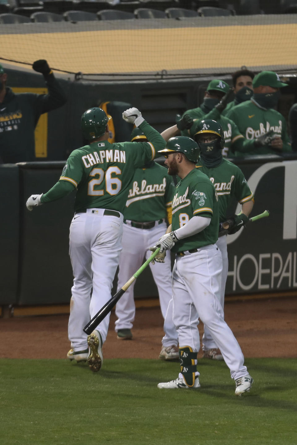 Oakland Athletics Matt Chapman is congratulated after hitting a solo home run against the Texas Rangers during the seventh inning of a baseball game in Oakland, Calif., Tuesday, Aug. 4, 2020. (AP Photo/Jed Jacobsohn)