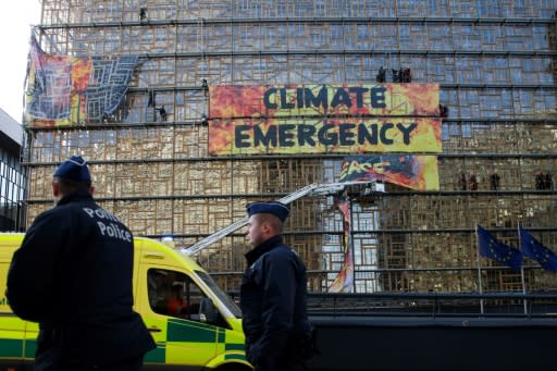 Before the European summit could even begin, police and firefighters were forced to intervene to dislodge Greenpeace protesters who scaled the side of the main venue