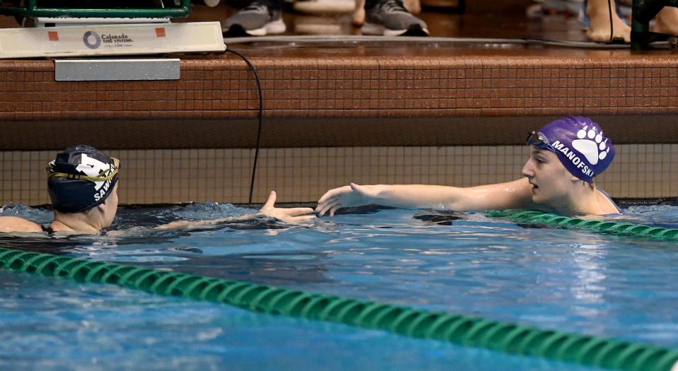 Hudson’s Ava Sawicki and Jackson’s Abra Manofsky in the girls 100-yard freestyle in the Division I district meet at Cleveland State, Saturday, Feb. 17, 2024.