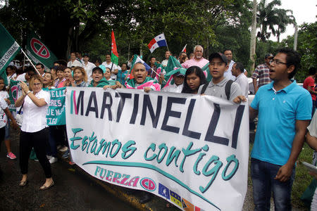 Supporters of former Panama president Ricardo Martinelli hold a banner reading: "Martinelli, we are with you" during a protest outside the Supreme Court in Panama City, Panama June 11, 2018. REUTERS/Carlos Lemos