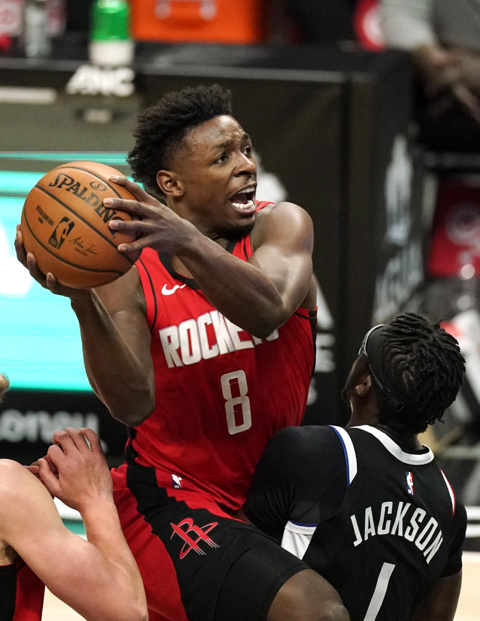 Houston Rockets forward Jae'Sean Tate, left, shoots as Los Angeles Clippers guard Reggie Jackson defends during the first half of an NBA basketball game Friday, April 9, 2021, in Los Angeles. (AP Photo/Mark J. Terrill)