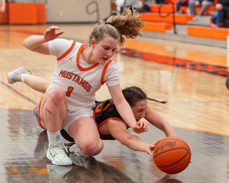 Brighton's Mary Copple and Northville's Lauren Talcott (1) battle for a loose ball during the Bulldogs' 43-41 victory on Friday, Jan. 13, 2023.