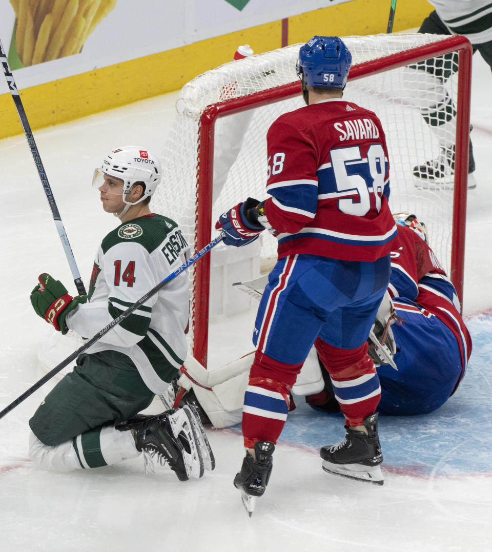 Minnesota Wild's Joel Eriksson Ek (14) celebrates his goal over Montreal Canadiens goaltender Sam Montembeault (35) and David Savard (58) during the second period of an NHL hockey game, Tuesday, Oct. 17, 2023 in Montreal. (Christinne Muschi/The Canadian Press via AP)