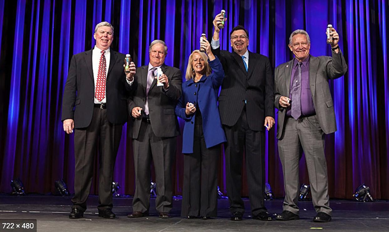 Dairy Management Inc. CEO Thomas Gallagher, second from right, at a 2014 announcement of more than $500 million in fluid milk partnerships with seven major companies. Gallagher retired in November 2021.