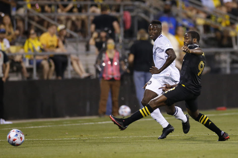 Chicago Fire's Jhon Espinoza, left, clears the ball past Columbus Crew's Kevin Molino during the second half of an MLS soccer match Saturday, June 19, 2021, in Columbus, Ohio. (AP Photo/Jay LaPrete)