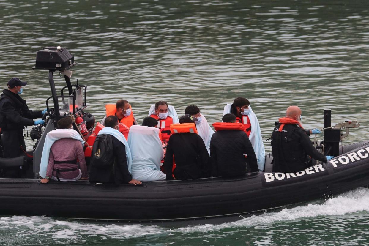 A group of people thought to be migrants are brought into Dover, Kent, onboard a Border Force vessel on August 16: PA