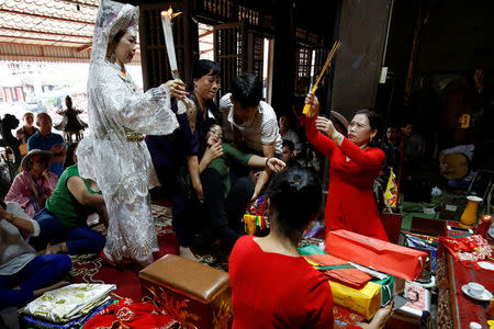 Pham Thi Thanh reacts during a ritual at a Hau Dong ceremony at Phu Day temple in Nam Dinh province, outside Hanoi, Vietnam, May 7, 2017. REUTERS/Kham