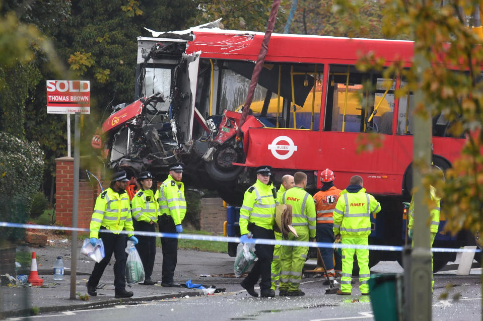 Police and recovery workers remove a damaged bus from the scene of a crash in Sevenoaks Road, Orpington, south-east London, where a man has been arrested on suspicion of causing death by dangerous driving after a crash in which a person died and 15 others were injured.