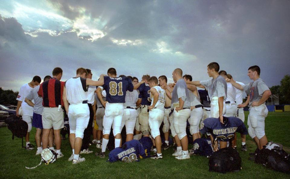 Elmira Notre Dame football players huddle in prayer at the end of practice Sept. 30, 1998 The team remembered Joel Stephens, a former Crusaders standout in football, baseball and basketball, who died earlier in the day.