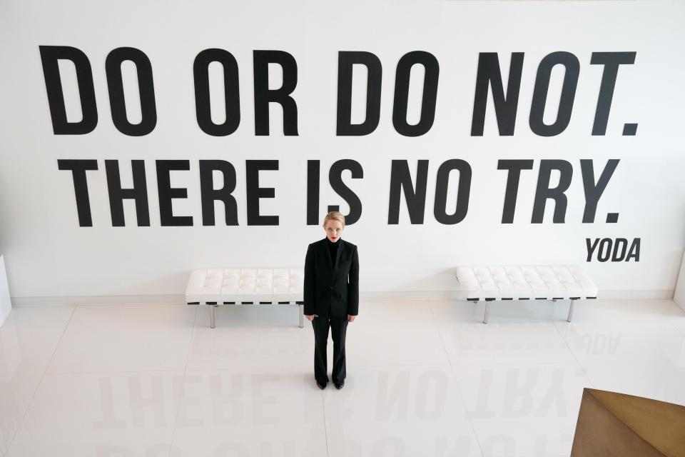 Amanda as Elizabeth standing in front of a wall that says "Do or do not, there is no try"