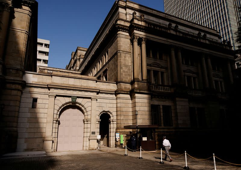 FILE PHOTO: A man walks at the headquarters of Bank of Japan in Tokyo