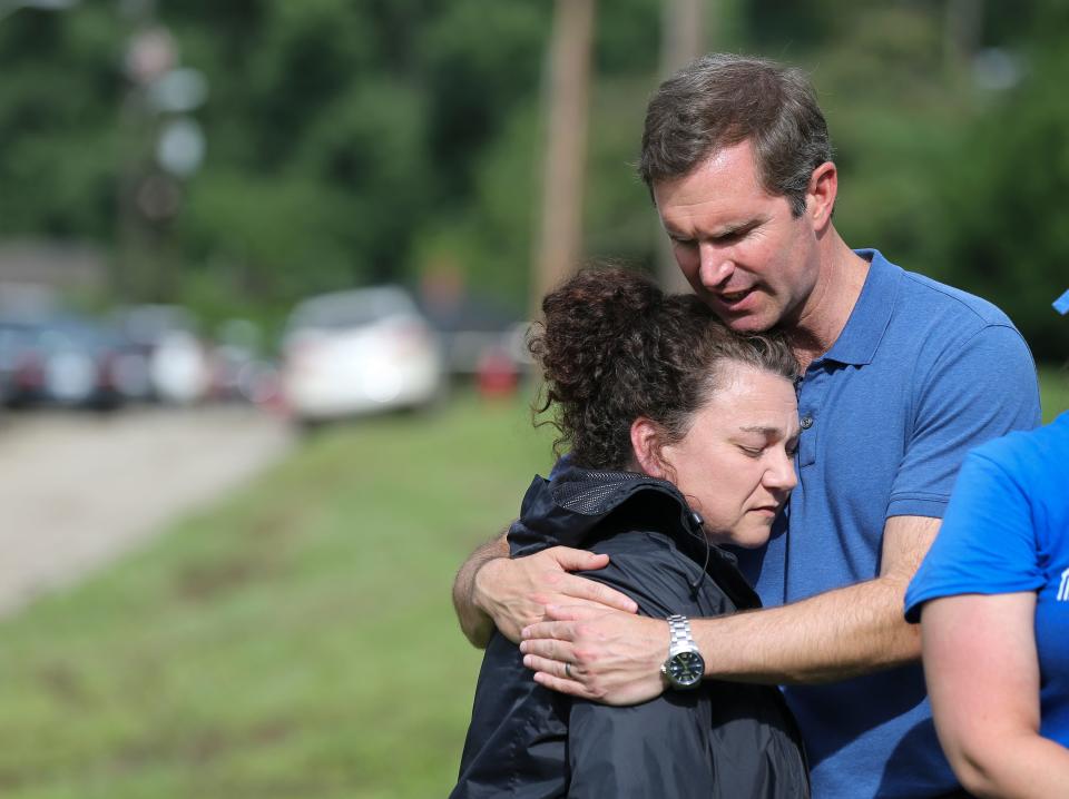 Governor Andy Beshear embraced State Rep. Angie Hatton as officials made remarks following the widespread destruction caused by flooding in Whitesburg, Ky. on July 31, 2022.  The floods devastated the region which resulted in the deaths of over 20 people.