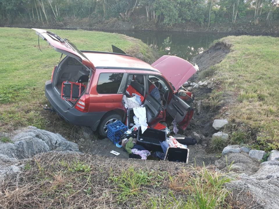 Photo of a red Subaru Forrester inside a ditch in Cairns. 