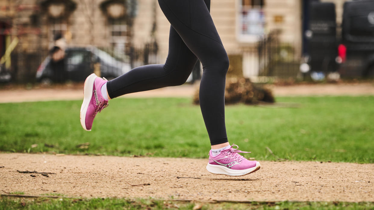  Woman wearing Saucony Ride 17 running shoes. 