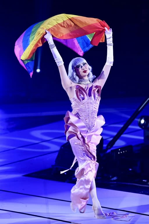 A performer displays a rainbow flag on stage during the opening ceremony for the Asia Pride Games (AFP/Sam Yeh)