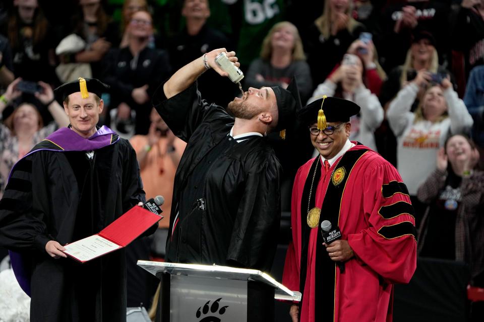 Travis Kelce chugged a beer before receiving his University of Cincinnati diploma on Thursday.