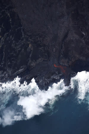 Lava pours into the ocean after crossing Highway 137 near Kapoho, May 28, 2018. REUTERS/Marco Garcia