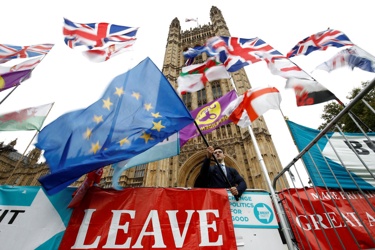 An anti-Brexit protester waves an EU flag outside the Houses of Parliament in London, Britain, October 25, 2019. REUTERS/Henry Nicholls