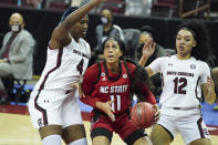 North Carolina State forward Jakia Brown-Turner (11) looks for a shot against South Carolina's Aliyah Boston (4) and Brea Beal (12) during the first half of an NCAA college basketball game Thursday, Dec. 3, 2020, in Columbia, S.C. (AP Photo/Sean Rayford)