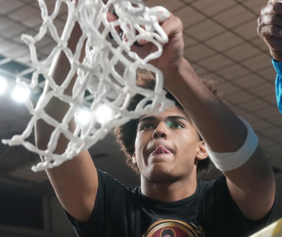 Perry Pumas’ Koa Peat (10) cuts down a piece of net after their 74-58 win over Sunnyslope Vikings for the Open Division State Championship at Arizona Veterans Memorial Coliseum in Phoenix on March 4, 2023.