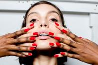 <p>Manicurist Holly Falcone outfitted shaped the model’s almond-shaped nails with a combination of Orly Breathable Treatment and a true red crème color called Love My Nails.(Photo: Orly Products) </p>