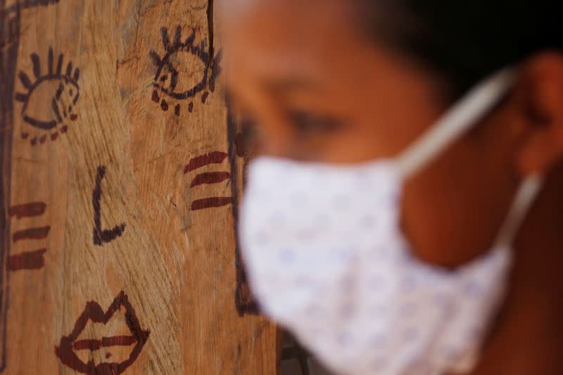 A woman from the Guajajara indigenous ethnic group wears a protective mask at a community school in the indigenous village of Morro Branco