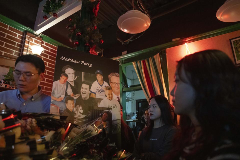 Fans of the hit sit-com "Friends" gather at a cafe that pays homage to the Central Perk cafe in the series to commemorate the death of Matthew Perry who played the Chandler Bing character, in Shanghai, Wednesday, Nov. 1, 2023. Long before "Friends" made its official debut in China, the show was a word-of-mouth phenomenon in the country. In the wake of Matthew Perry's death at 54, fans in China are mourning the loss of the star who felt less like a distant celebrity and more like an old friend. (AP Photo/Ng Han Guan)