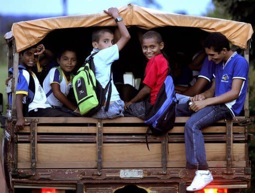 Children head back home after attending school in Xapuri, in northern Brazil. Teachers, who are scarce in the Amazon, are now conducting lessons streamed to students in the village of Tumbira using an Internet connection made possible with a generator-powered radio signal