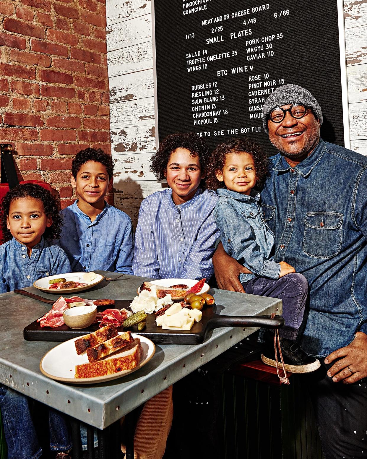 André Mack and his four sons at his Brooklyn ham bar, &amp; Sons