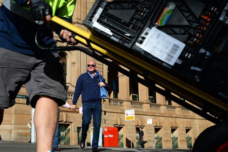 A man crosses a road in the central business district in Sydney, Australia on May 7, 2013