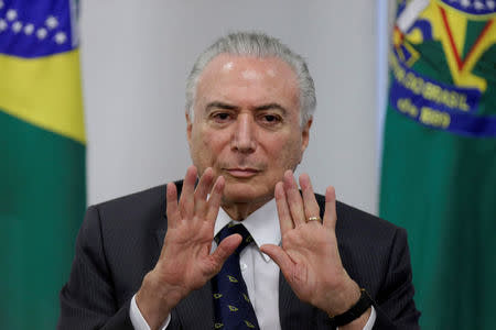 REFILE - REMOVING RESTRICTIONS FILE PHOTO: Brazil's President Michel Temer gestures during a ceremony to announce the resumption of works of urban mobility in the city of Goiania, at the Planalto Palace in Brasilia, Brazil March 15, 2018. REUTERS/Ueslei Marcelino/File photo