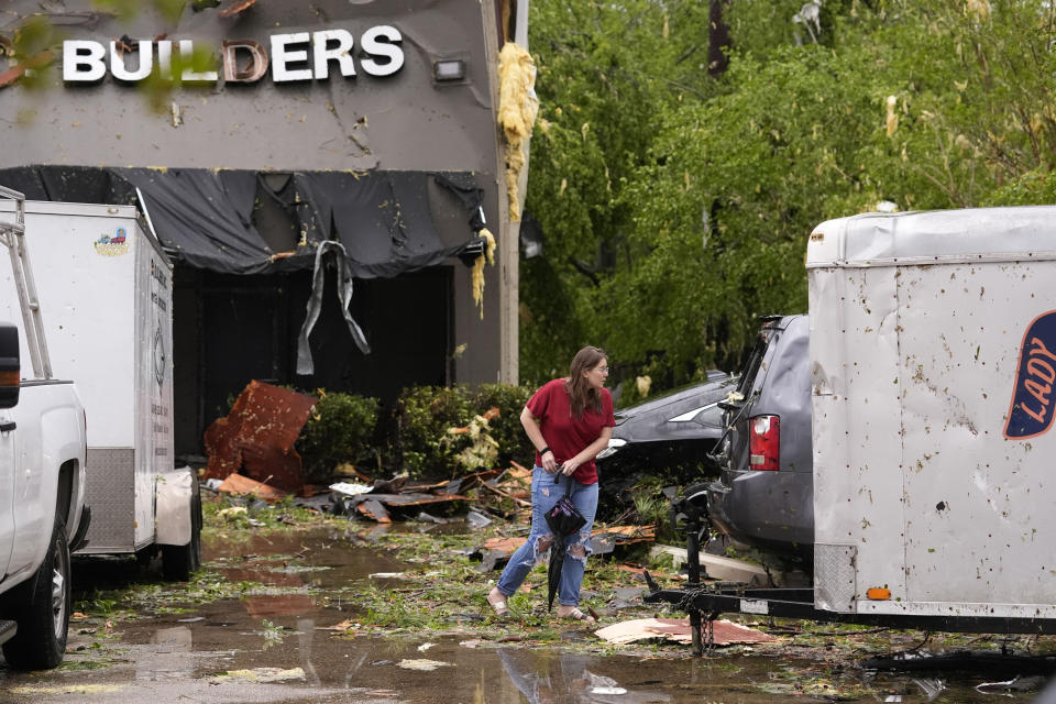 A woman walks amidst rubble of a heavily damaged building in the aftermath of severe storms that swept through the region in Slidell, La., Wednesday, April 10, 2024. (AP Photo/Gerald Herbert)