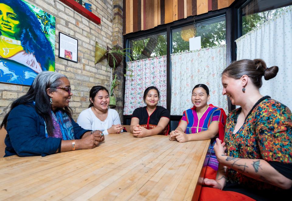 Tables Across Borders founder Kai Yael Gardner Mishlove, from left, chats with May Paw, Hainay Say, Haynay Paw and Tricklebee Cafe Executive Director Christie Melby-Gibbons on Aug. 10, 2023 about plans to cook Karen cuisine at a future dinner.