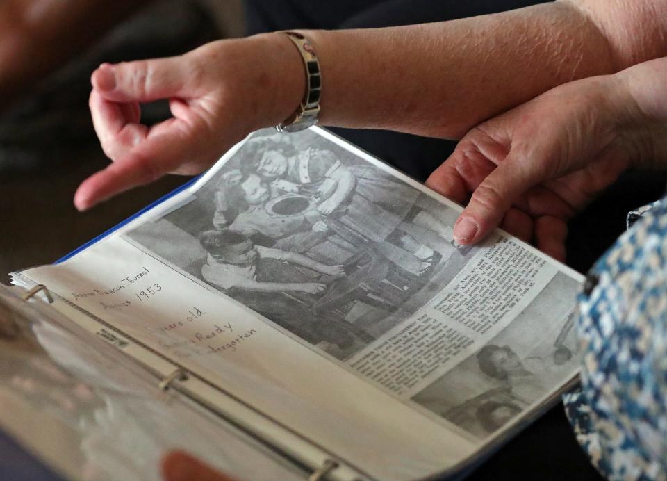 Cousins Marie Buehler and Phyllis Antonino reminisce Tuesday as they look at clippings from the Akron Beacon Journal.