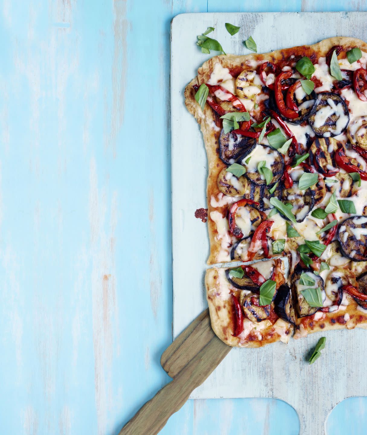 grilled vegetable pizza on a wooden serving board