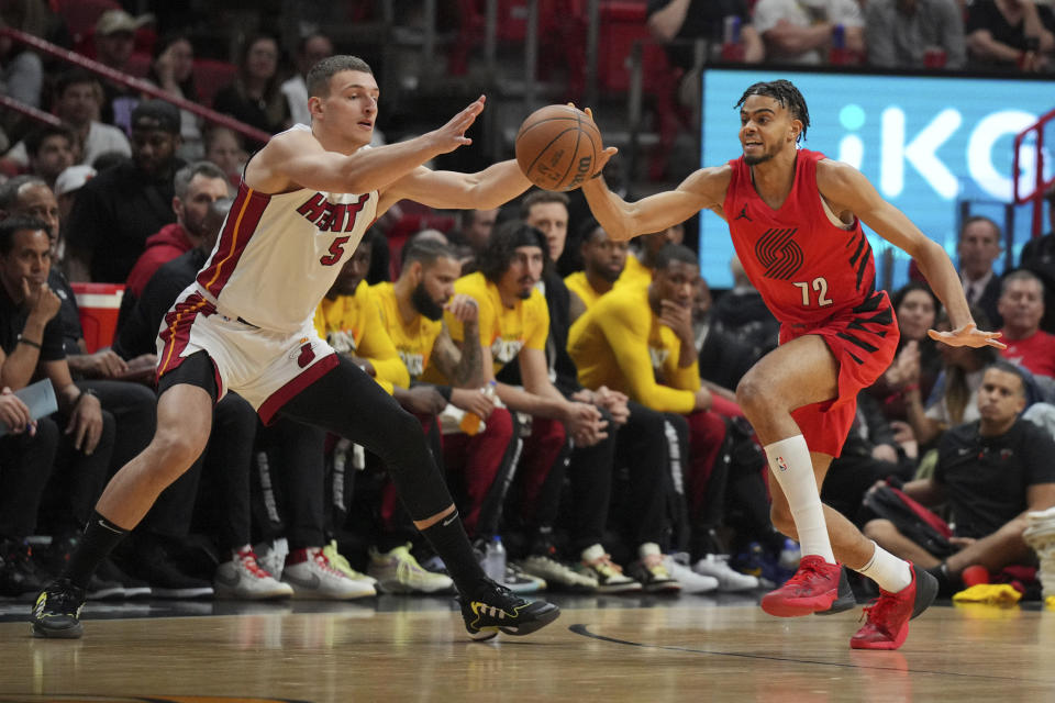 Portland Trail Blazers guard Rayan Rupert (72) steals a pass intended for Miami Heat forward Nikola Jovic (5) during the first half of an NBA basketball game, Friday, March 29, 2024, in Miami. (AP Photo/Jim Rassol)
