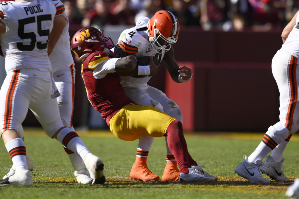 Cleveland Browns quarterback Deshaun Watson (4) is sacked by Washington Commanders linebacker Dante Fowler Jr. (6) during the second half of an NFL football game in Landover, Md., Sunday, Oct. 6, 2024. (AP Photo/Nick Wass)