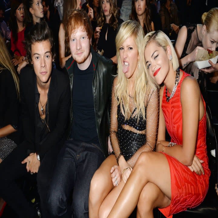 From left to right: Harry Styles, Ed Sheeran, Ellie, and Rita Ora sitting at an event