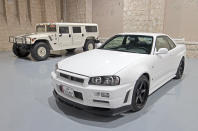 <p>Most cars are grouped by brand and/or era, but near the entrance is a hotch-potch of modern high-performance cars including this Nissan Skyline GT-R, behind which is an example of the original Hummer, the H1.</p>