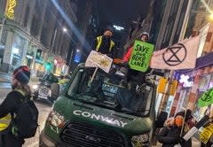 Activists climbed onto a work van that had arrived to remove bollards lining the high street (Extinction Rebellion London / Twitter )