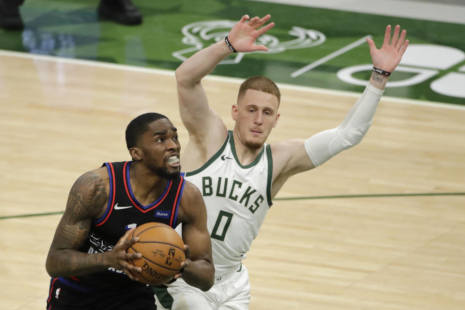 Philadelphia 76ers' Shake Milton drives to the basket against Milwaukee Bucks' Donte DiVincenzo (0) during the second half of an NBA basketball game Thursday, April 22, 2021, in Milwaukee. (AP Photo/Aaron Gash)