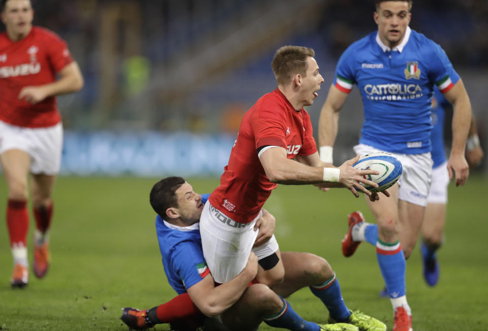 Wales' Liam Williams, top, is tackled by Italy's Luca Morisi during the Six Nations rugby union international between Italy and Wales, at Rome's Olympic Stadium, Saturday, Feb. 9, 2019. (AP Photo/Andrew Medichini)