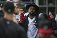 Chicago White Sox designated hitter Eloy Jimenez celebrates in the dugout after hitting a two-run home run during the first inning of a baseball game against the Minnesota Twins, Saturday, Sept. 16, 2023, in Chicago. (AP Photo/Erin Hooley)