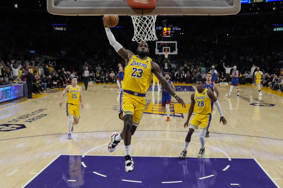 Los Angeles Lakers forward LeBron James (23) performs a dunk during the first half of Game 3 of a first-round NBA basketball playoff series against the Denver Nuggets in Los Angeles on Thursday, 25 April 2024. (AP Photo/Ashley Landis)